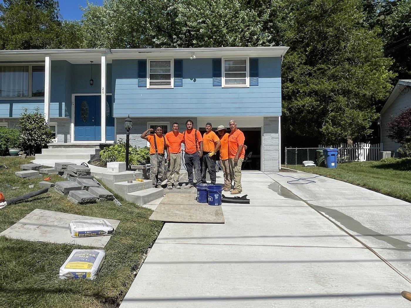 Papaneri and Sons crew standing on a finished commercial concrete driveway