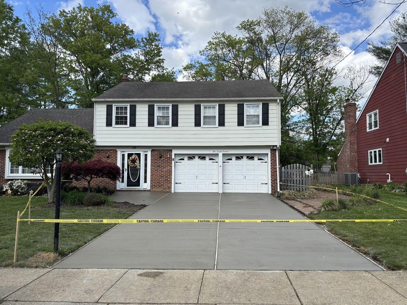 New concrete driveway at a brick colonial home in South Jersey