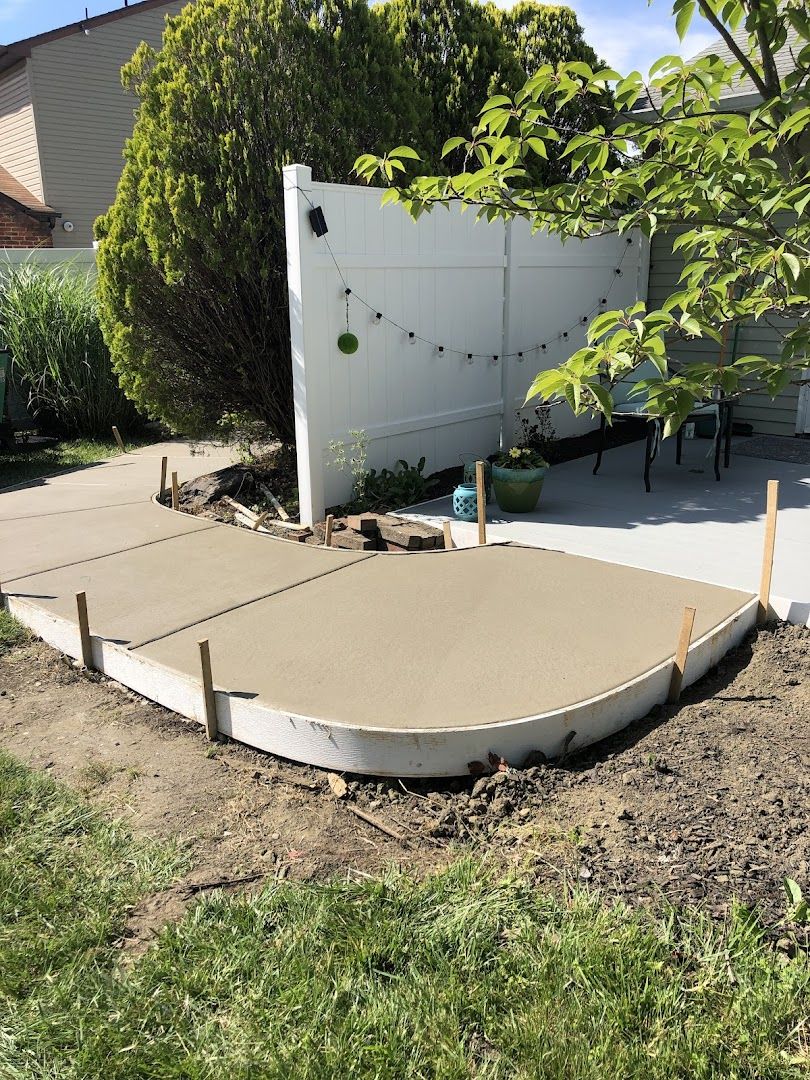 Freshly poured concrete patio slab in a South Jersey backyard