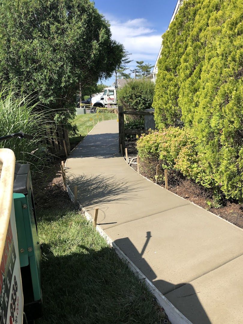 Fresh concrete sidewalk and walkway poured in front of a home